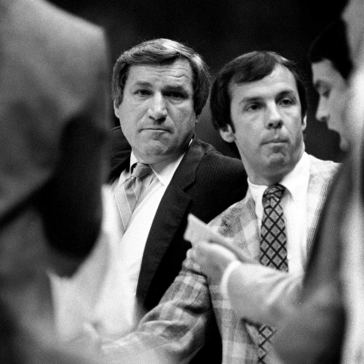 UNC coach Dean Smith with a young assistant coach Roy Williams during a 1979 game in Carmichael Auditorium in Chapel Hill, NC.