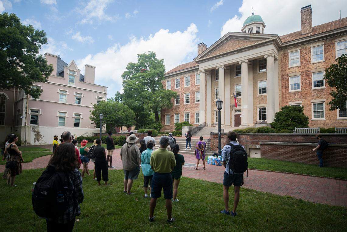 A small crowd of UNC-Chapel Hill students and staff gather outside South Building in Chapel Hill, N.C. for a demonstration, put on by the UNC chapter of the NAACP on Monday, July 12, 2021, in solidarity with students who protested a recent board of trustees meeting.