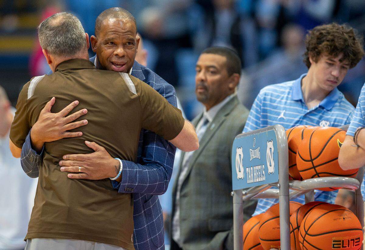 North Carolina coach Hubert Davis embraces Lehigh coach Dr. Brett Reed prior to their game on Sunday, November 12, 2023 at the Smith Center in Chapel Hill, N.C.