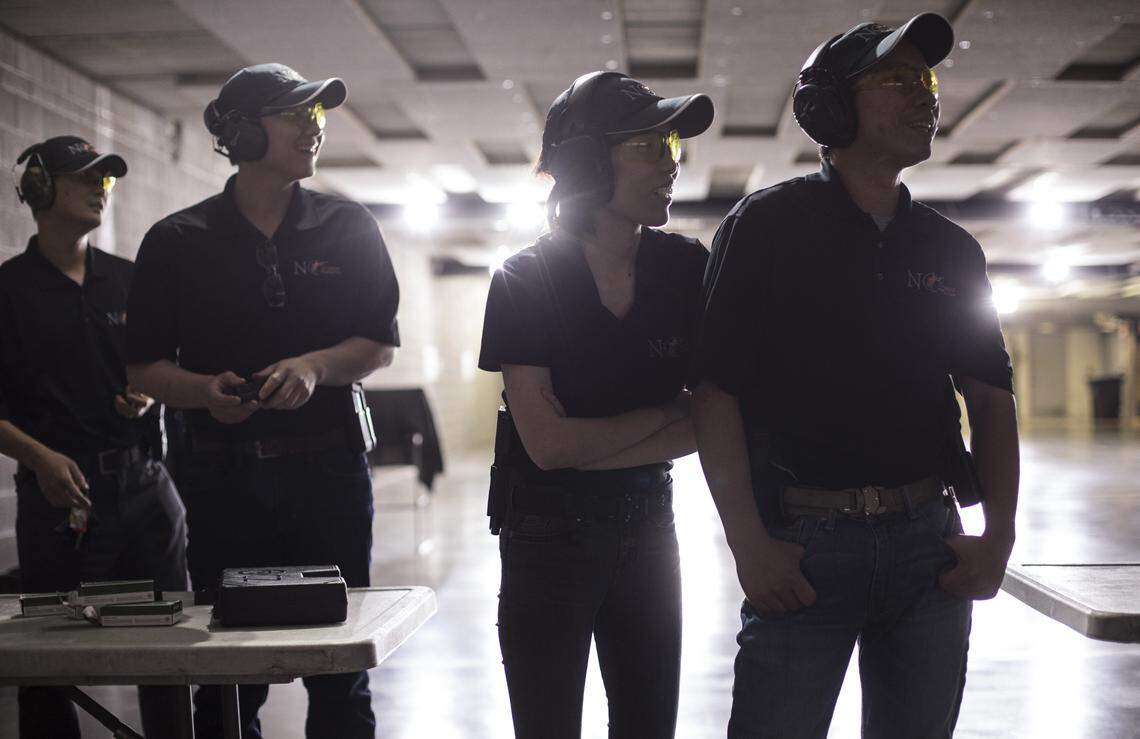 Members of the N.C. Chinese Hunting Club, who preferred not to be identified by name, smile as Wei Miao instructs their group on Sunday April 29, 2018 at the Wake County Firearms Education & Training Center in Apex, NC.
