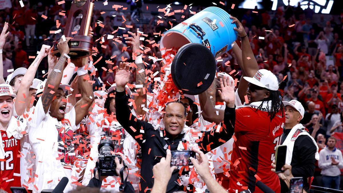 N.C. State head coach Kevin Keatts and the team celebrate the Wolfpack’s 76-64 victory over Duke in their NCAA Tournament Elite Eight matchup at the American Airlines Center in Dallas, Texas, Sunday, March 31, 2024.