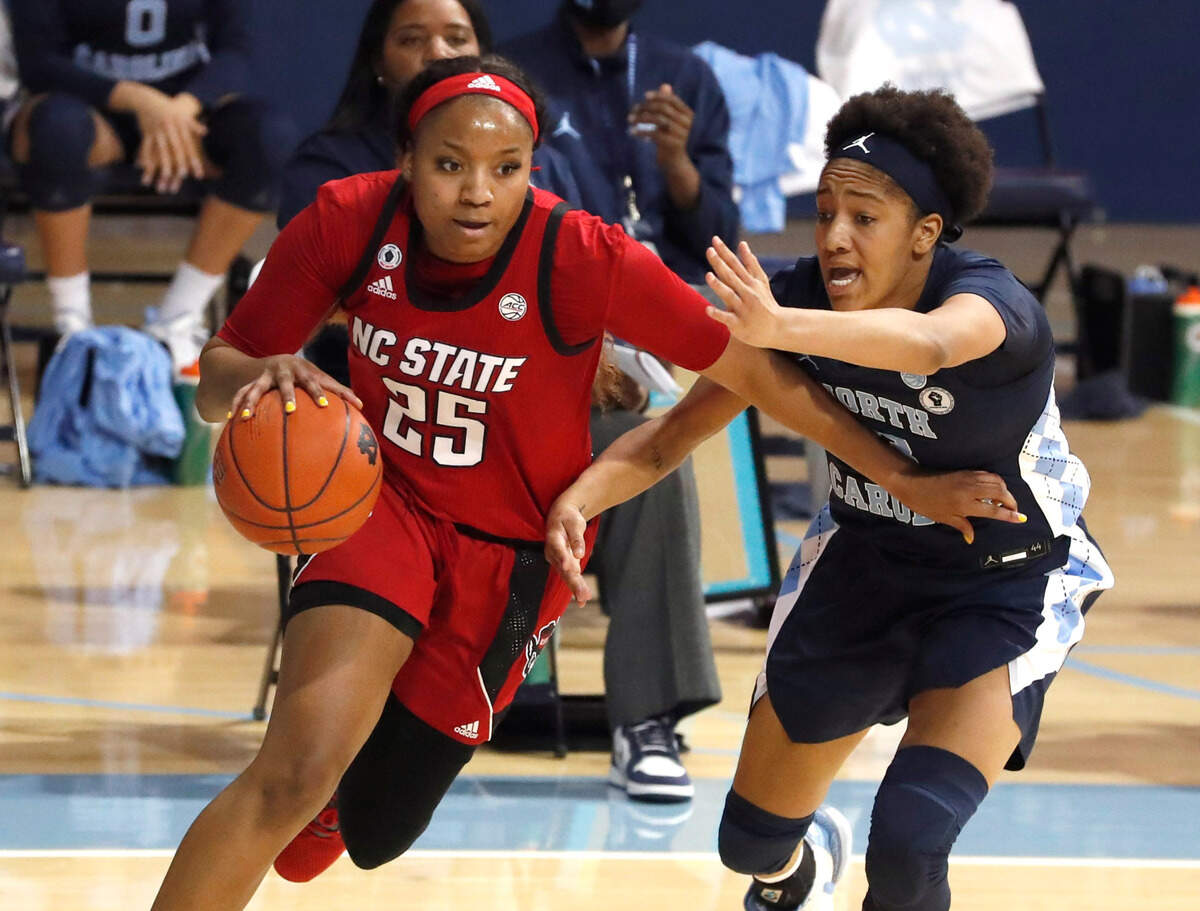 N.C. State’s Kayla Jones (25) drives by North Carolina’s Kennedy Todd-Williams (3) during the first half of N.C. State’s game against UNC at Carmichael Arena in Chapel Hill, N.C., Sunday, February 7, 2021.
