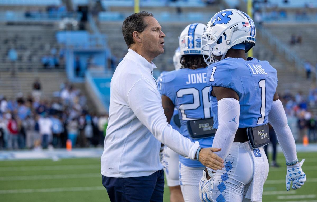 North Carolina assistant head coach for defense Gene Chizik talks with Antavious Lane (1) prior to the Tar Heels’ game against Virginia on Saturday, October 21, 2023 at Kenan Stadium in Chapel Hill, N.C.