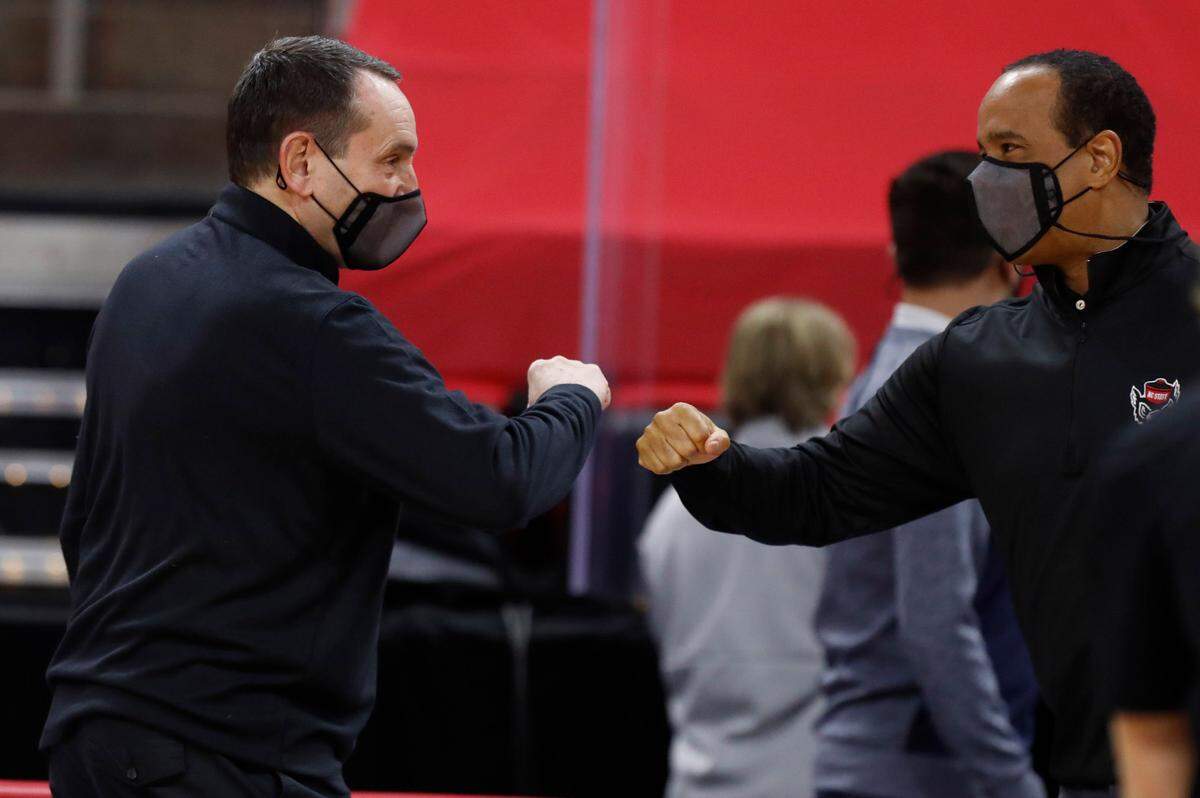 Duke head coach Mike Krzyzewski and N.C. State head coach Kevin Keatts great each other before N.C. State’s game against Duke at PNC Arena in Raleigh, N.C., Saturday, February 13, 2021.