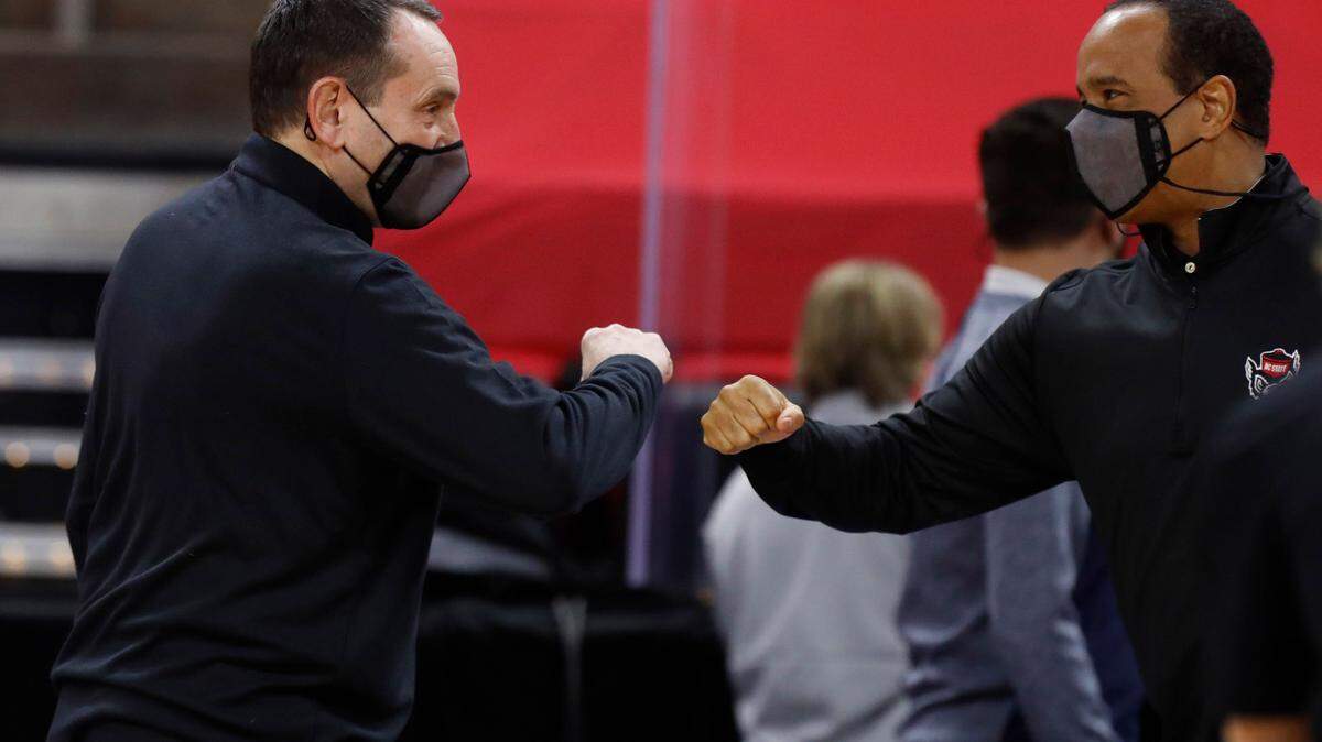 Duke head coach Mike Krzyzewski and N.C. State head coach Kevin Keatts great each other before N.C. State’s game against Duke at PNC Arena in Raleigh, N.C., Saturday, February 13, 2021.