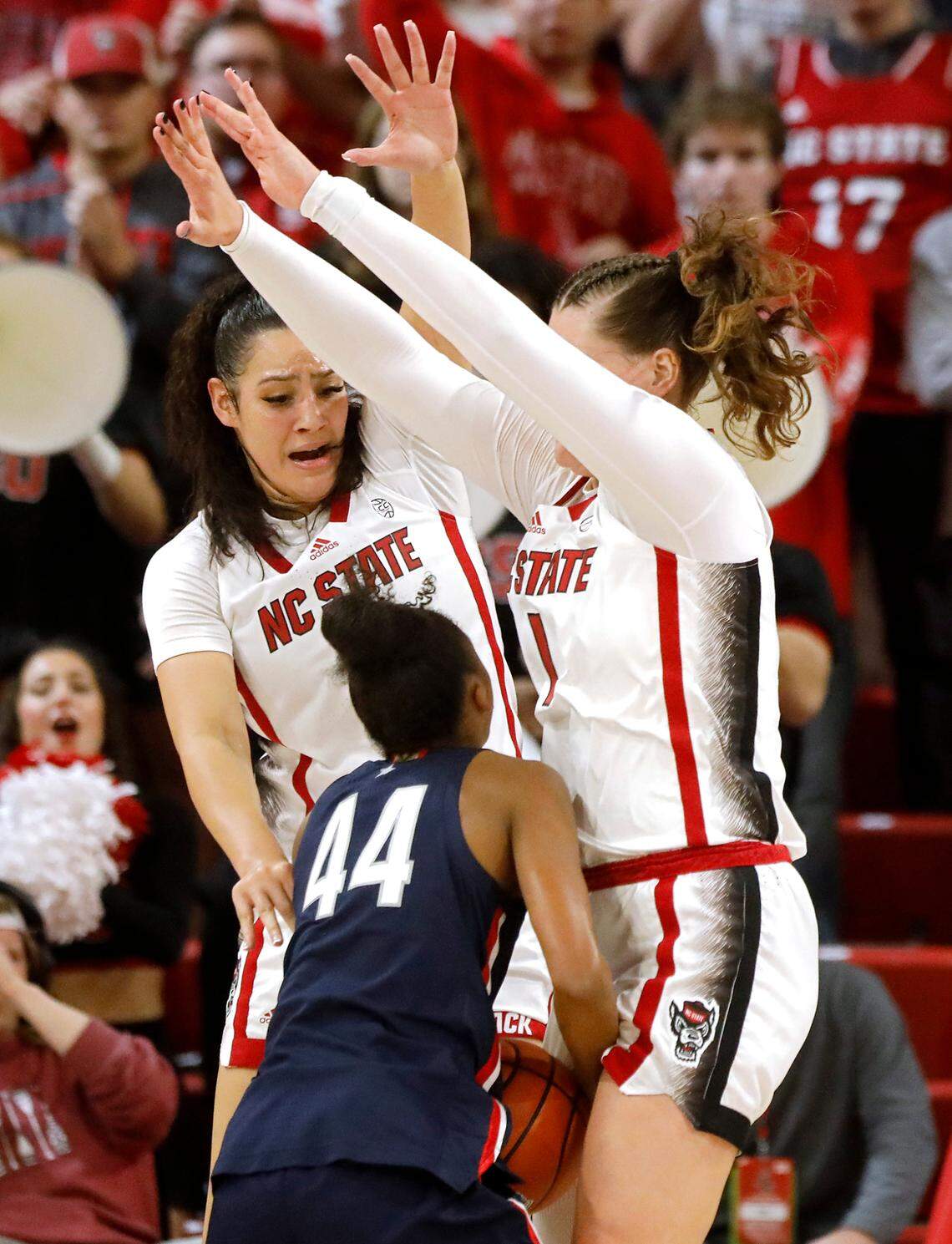 N.C. State’s Mimi Collins and River Baldwin swarm UConn’s Aubrey Griffin in the second half of the Wolfpack’s 92-81 win on Sunday, Nov. 12, 2023, at Reynolds Coliseum in Raleigh, N.C.