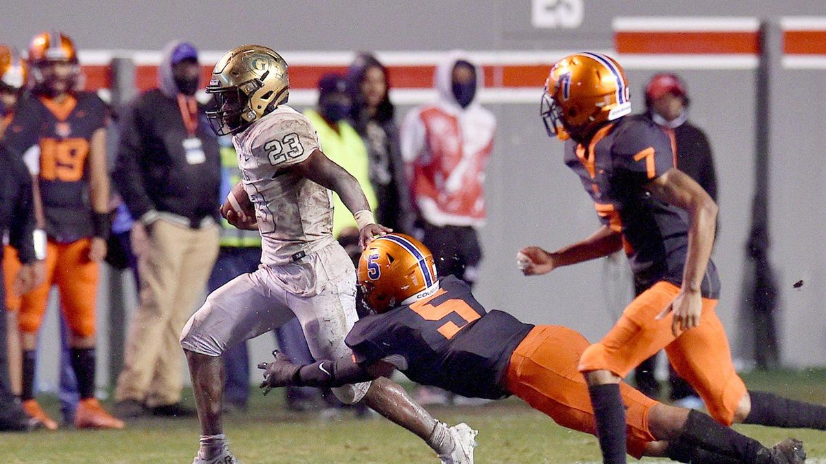 Cardinal Gibbons’ Donovan Shepard (23) runs for yardage against Chambers’ TJ McGill (5) during the second half. The Cardinal Gibbons Crusaders and the Julius Chambers Cougars met in the NCHSAA 4A Football Championship game in Raleigh, N.C. on December 11, 2021.