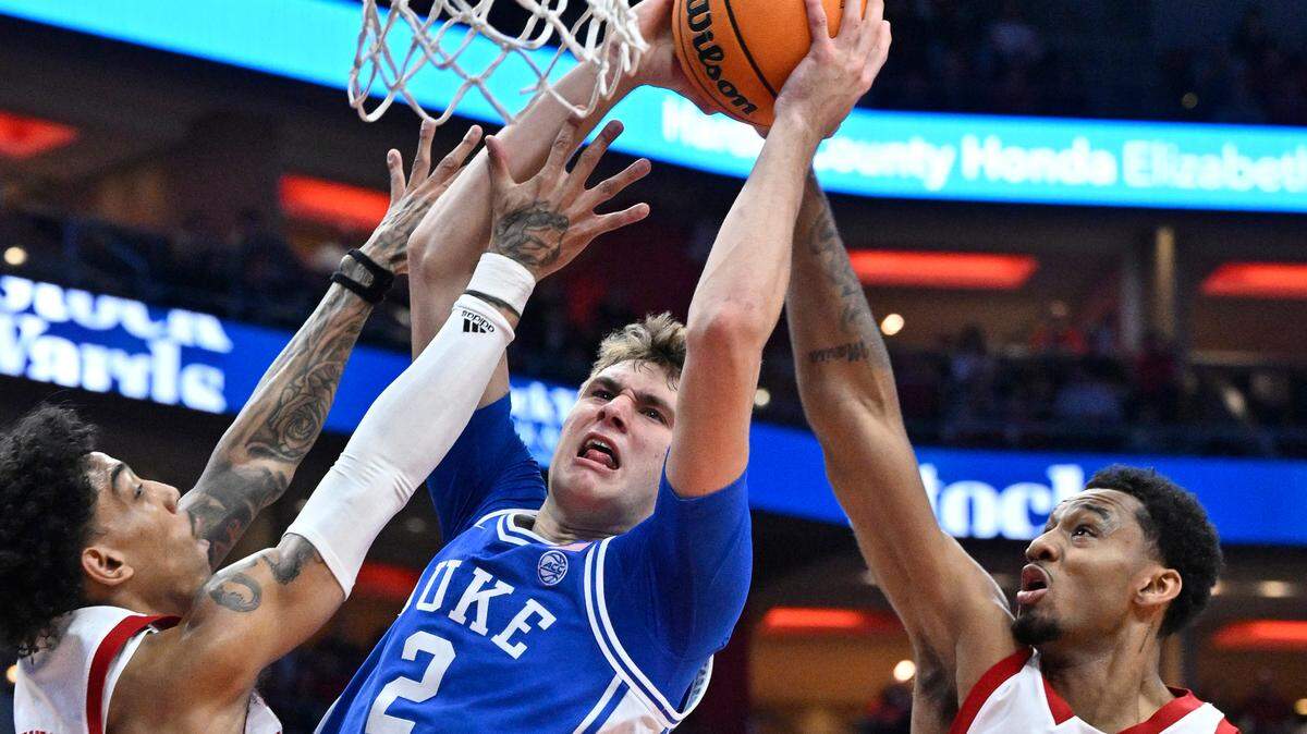Duke Blue Devils guard Cooper Flagg (2) shoots against Louisville Cardinals guard Terrence Edwards Jr. (5) and forward James Scott (0) during the first half at KFC Yum! Center on Sunday, Dec. 8, 2024.