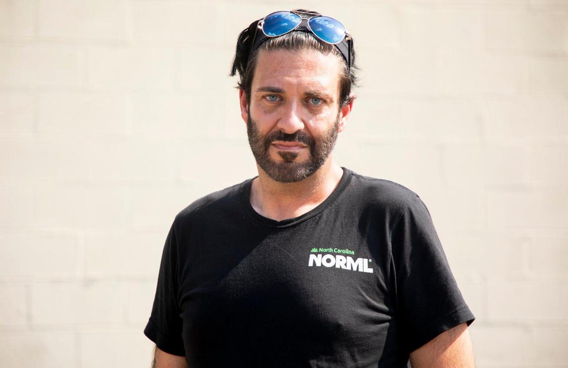 Chris Suttle, an advocate for legalization of medicinal cannabis, stands for a portrait outside the Cannabliss Dispensary, on Wednesday, July 7, 2021, in Chapel Hill, N.C.