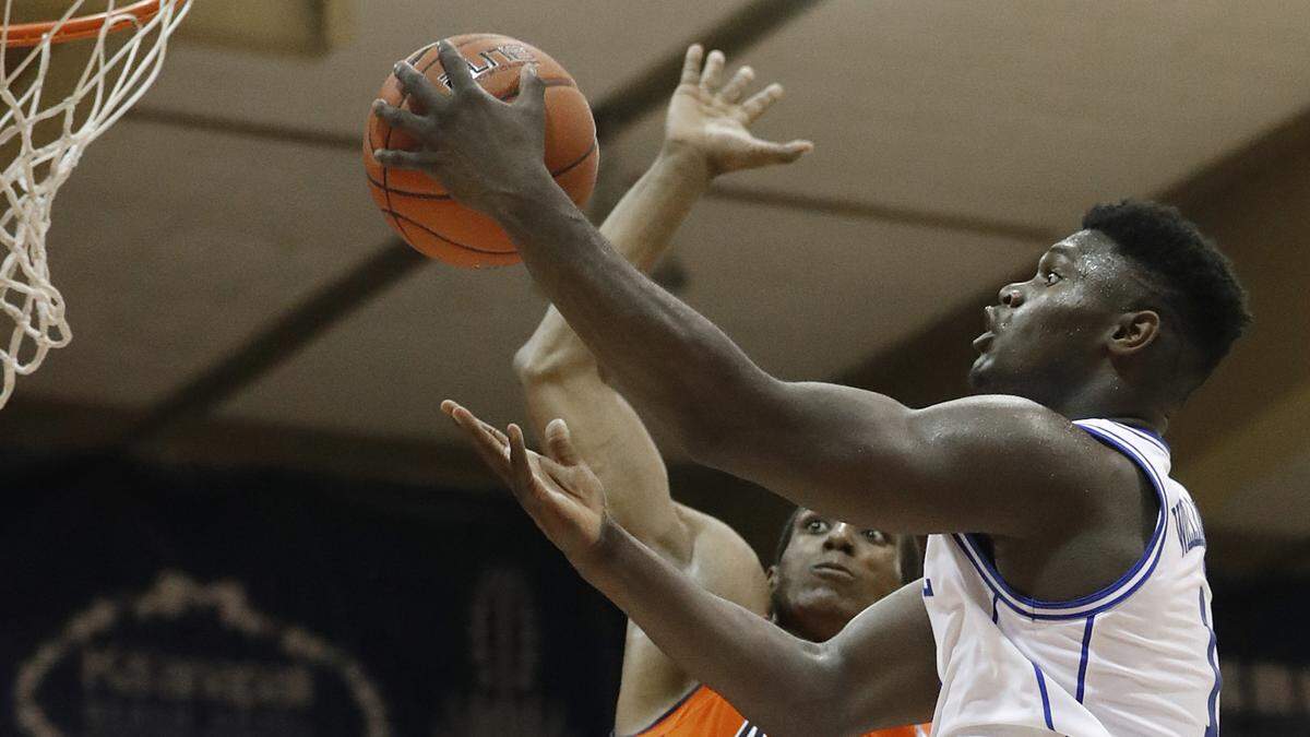 Auburn forward Horace Spencer (0) tries to stop Duke forward Zion Williamson (1) from reaching the basket during the second half of an NCAA college basketball game at the Maui Invitational, Tuesday, Nov. 20, 2018, in Lahaina, Hawaii. Duke defeated Auburn 78-72.