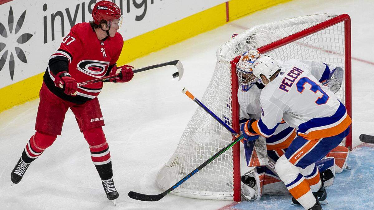 Carolina Hurricanes’ Andrei Svechnikov (37) balances the puck on his stick as he works behind New York Islander goalie Ilya Sorokin (30) in the third period on Thursday, October 14, 2021 at PNC Arena in Raleigh, N.C.