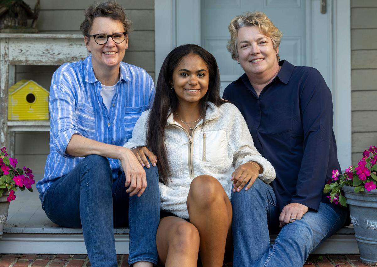 Guardians Caitlin Meagher, left and Sarah Roberson, right with Marissa Blount at their home on Tuesday, May 21, 2024 in Raleigh, N.C.