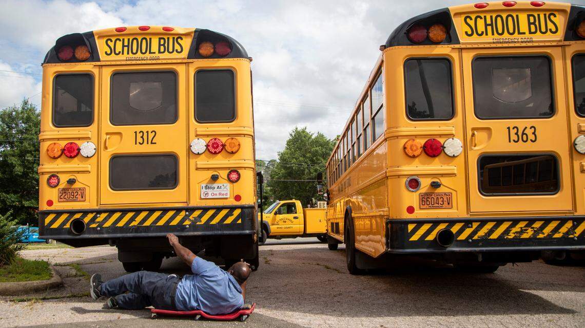 Sherwin Edwards, a mechanic with Wake County Schools Transportation Department, pulls maintenance on buses at a former car dealership parking lot on Capital Boulevard in Raleigh Wednesday, July 8, 2020. Reopening of Wake County Public Schools for face-to-face classes in uncertain amid coronavirus concerns.