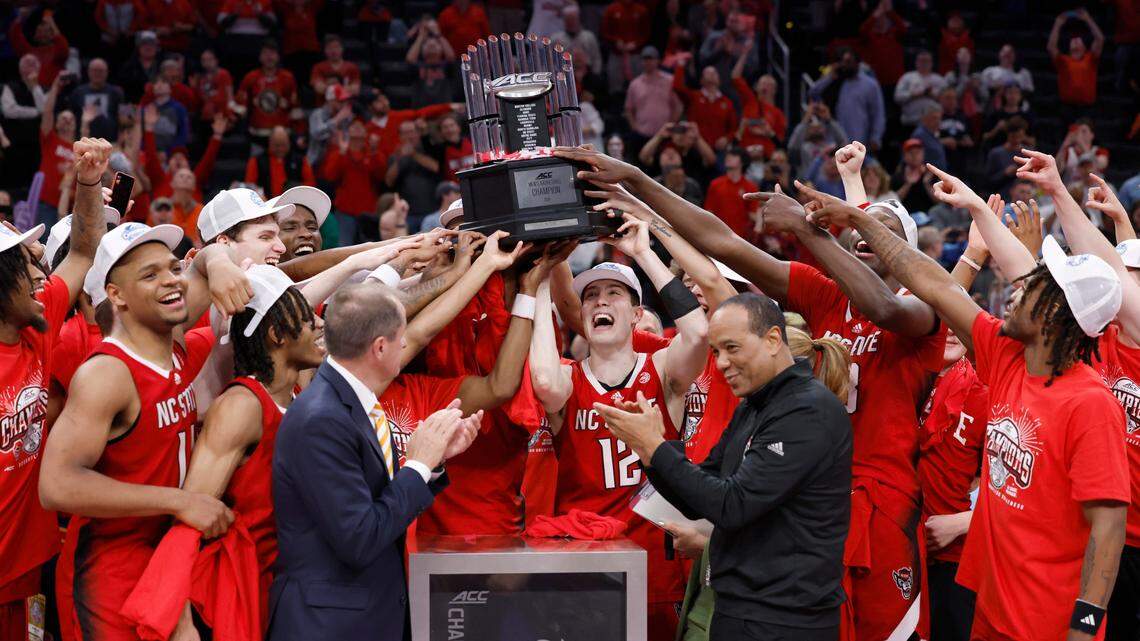 The N.C. State team raises the championship trophy after the Wolfpack’s 84-76 victory over UNC in the championship game of the 2024 ACC Men’s Basketball Tournament at Capital One Arena in Washington, D.C., Saturday, March 16, 2024.