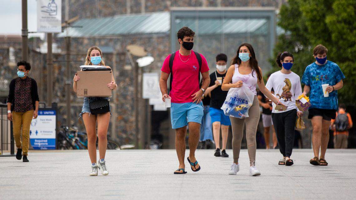 Wearing masks to prevent the spread of COVID-19, students make their way through campus at Duke University on Tuesday, Sept. 1, 2020, in Durham, N.C.
