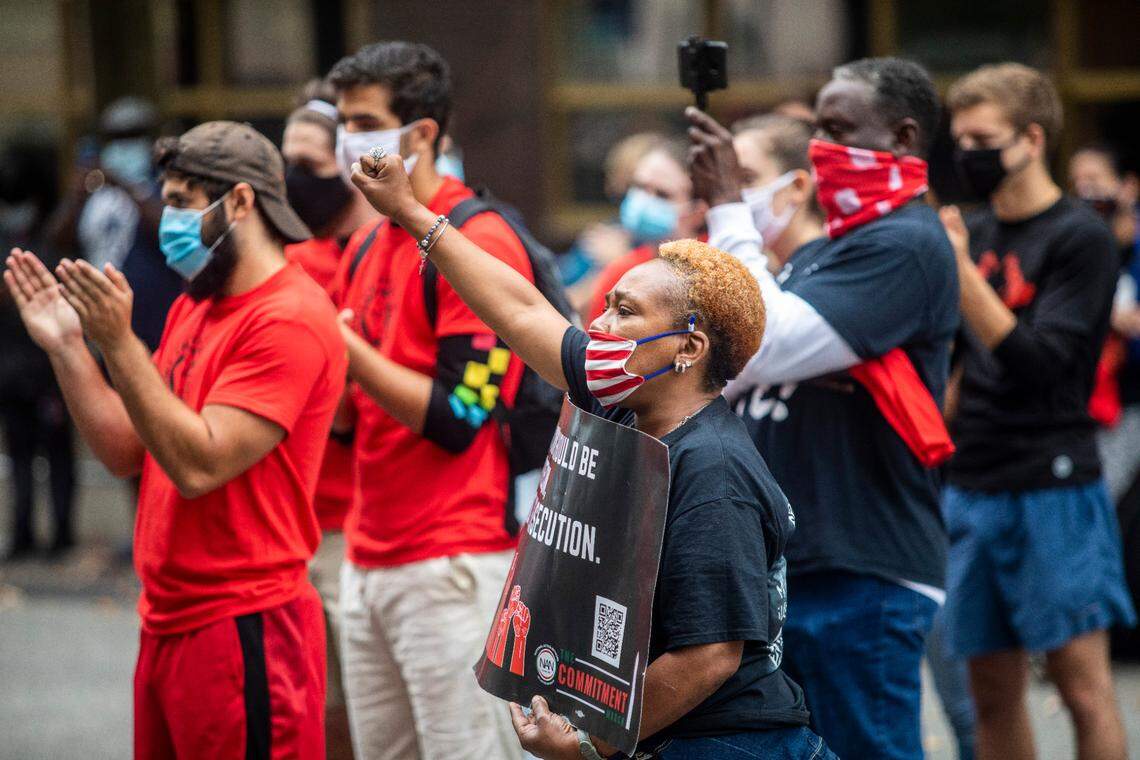 Demonstrators including Carrie Smith Raleigh, foreground, listen to speeches during a rally in downtown Raleigh Saturday Sept. 26, 2020 in protest of the Kentucky grand jury’s decision in the Breonna Taylor police shooting.
