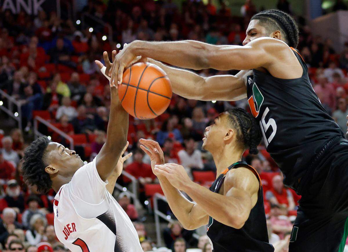 N.C. State’s Jarkel Joiner battles for a rebound with Miami’s Isaiah Wong and Norchad Omier during overtime of the Wolfpack’s 83-31 win over Miami at PNC Arena on Saturday, Jan. 14, 2023, in Raleigh, N.C.