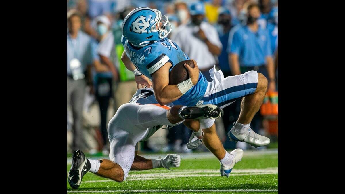 Virginia’s Joey Blount (29) stops North Carolina quarterback Sam Howell (7) after a three-yard gain in the third quarter on Saturday at Kenan Stadium in Chapel Hill. Blount is not expected to be penalized by the league for a hit on Josh Downs.