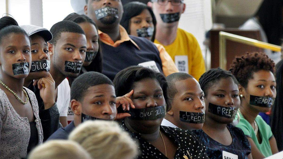 In this 2013 photo, opponents of voter ID wear black tape over their mouths as a sign of protest during a legislative debate in Raleigh. In 2018, the N.C. Supreme Court struck down a new voter ID law. In May 2023, the court, with its new Republican majority, reversed that decision.