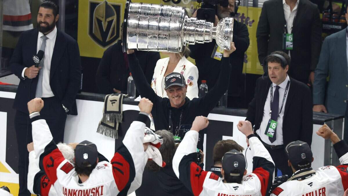 Carolina Hurricanes owner Tom Dundon raises the Cup after the Hurricanes’ 3-0 victory over the Vegas Golden Knights to win the Stanley Cup at T-Mobile Arena in Las Vegas, Nev., Sunday, June 14, 2026.
