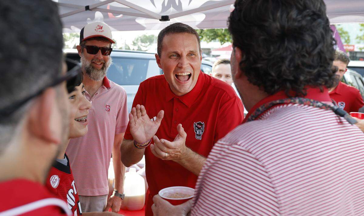 N.C. State basketball coach Will Wade laughs with fans while tailgating before N.C. State's game against ECU at Carter-Finley Stadium in Raleigh, N.C., Thursday, August 28, 2025.
