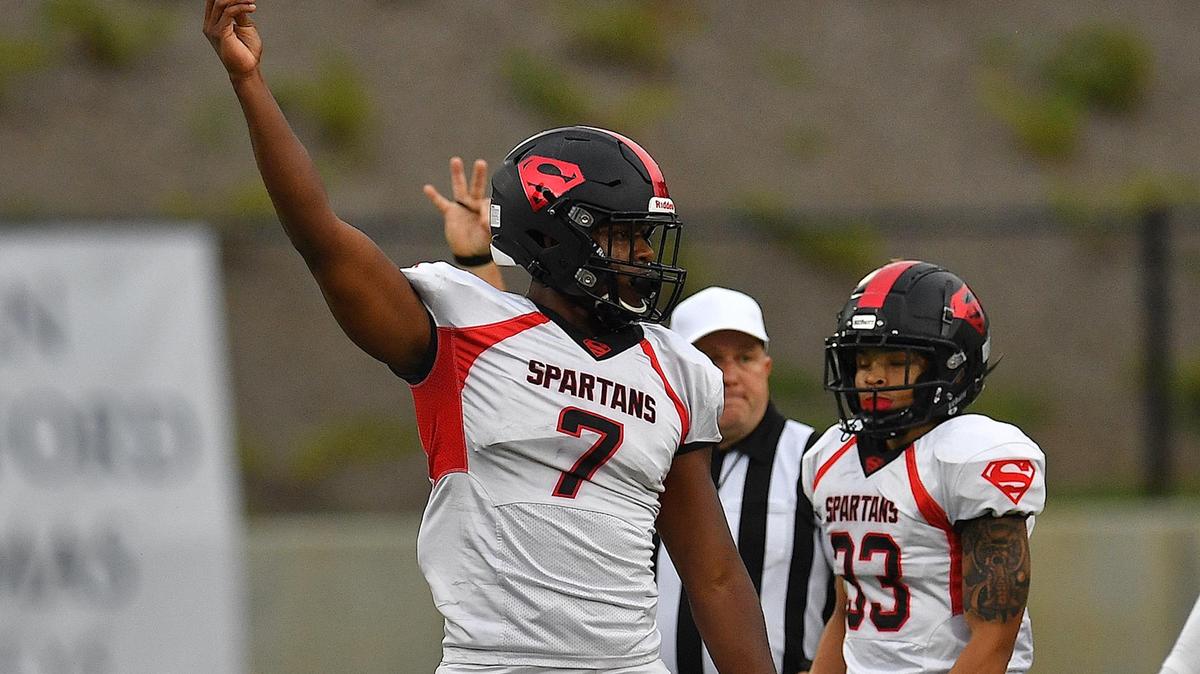 Southern Durham’s Jaybron Harvey (7) signals to players after a play during the first hALF. The Wake Forest Cougars and the Southern Durham Spartans met in a football game in Wake Forest, N.C. on August 19, 2022.