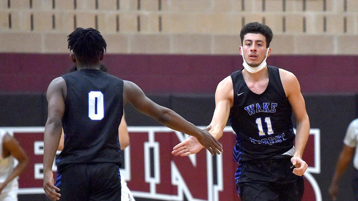 Wake Forest’s Jaden Valentine congratulates Cem Oztamur (11) after making the shot in the second half. The Wake Forest Cougars and the Wakefield Wolverines met in a conference basketball game in Raleigh, NC on February 4, 2022.