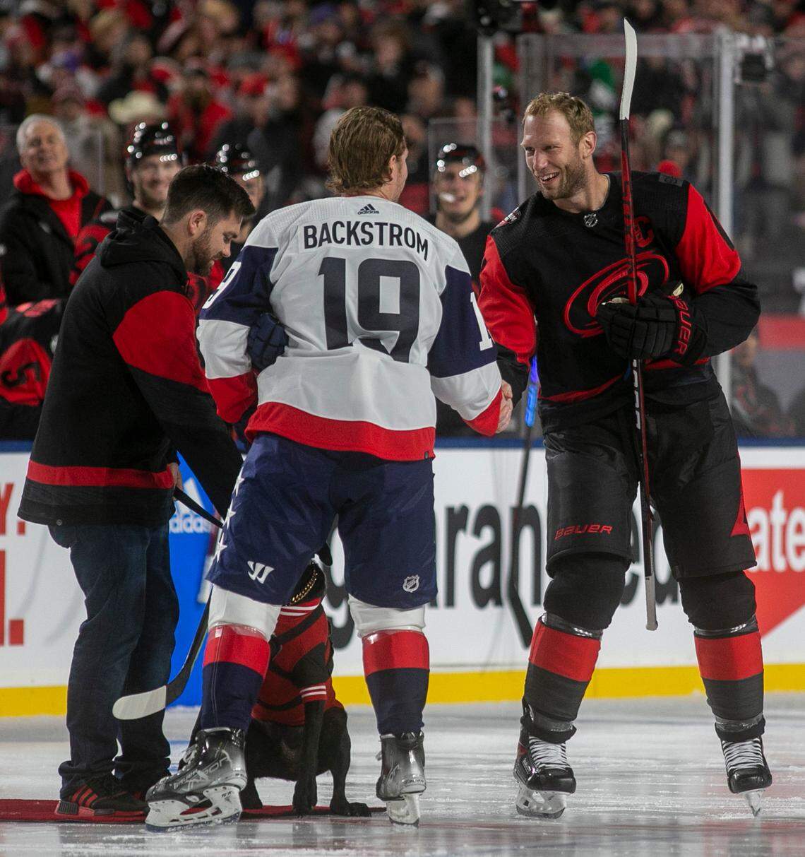 Carolina Hurricanes’ Jordan Staal (10) shakes hands with Washington Capitals’ Nicklas Backstroke (19) following the ceremonial puck drop, prior the Stadium Series game on Saturday, February 18, 2022 at Carter-Finley Stadium in Raleigh, N.C.