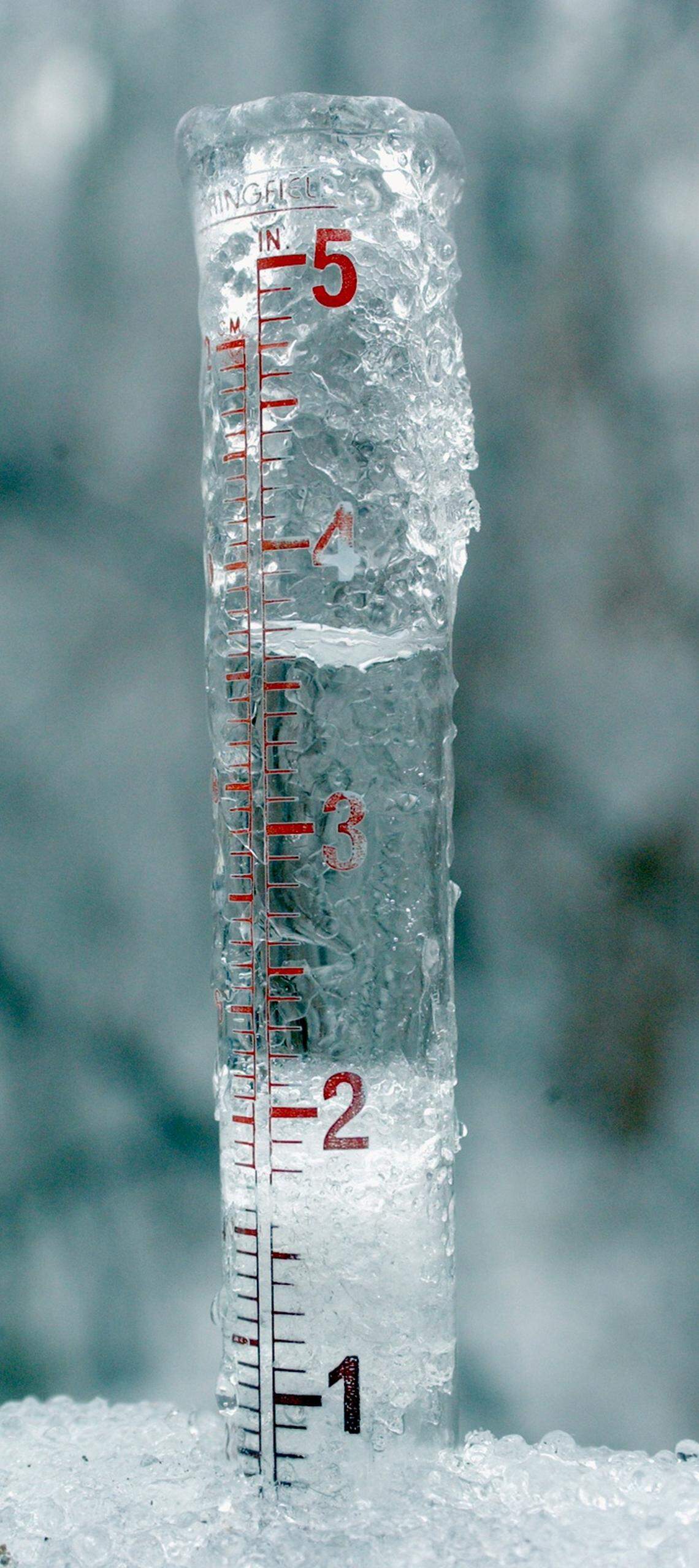 This rain gauge in north Durham County tells the story: frozen solid at the 2 inch mark and liquid water up to the 3 and three-quarter inch mark shows the weather we've had in the last 24 hours.  The ice build up has caused power lines to break as well as tree limbs and whole trees to fall on the lines, causing widespread power outages in the Triangle area.