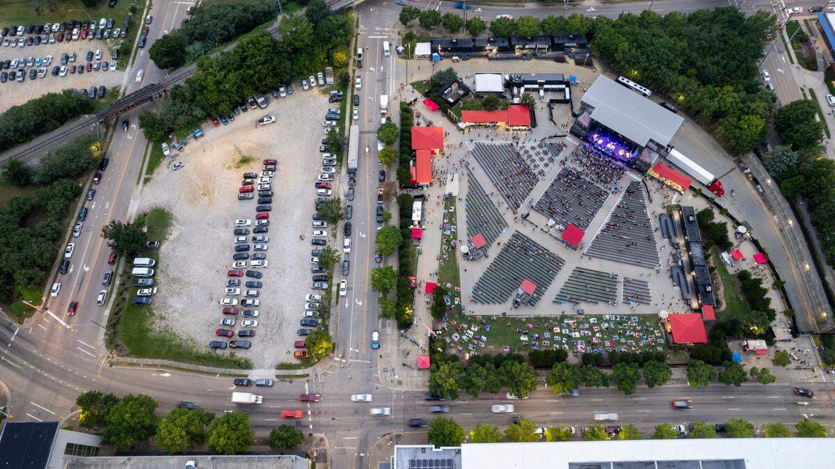 An aerial view of Red Hat Amphitheater, at right, with the intersection of South and McDowell Streets to the far left as seen prior to a concert on Tuesday, Aug. 13, 2024. A proposed plan to relocate Red Hat Amphitheater would permanently close a block of South Street to traffic.
