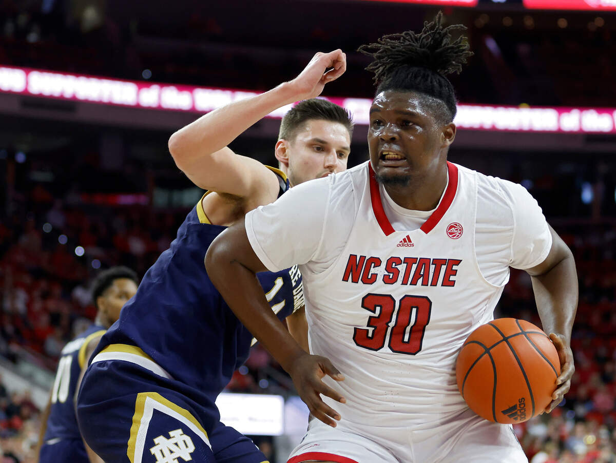 North Carolina State’s D.J. Burns Jr. drives past Notre Dame’s Nate Laszewski during the first half of a men’s basketball game at PNC Arena on Tuesday, Jan. 24, 2023, in Raleigh, N.C.