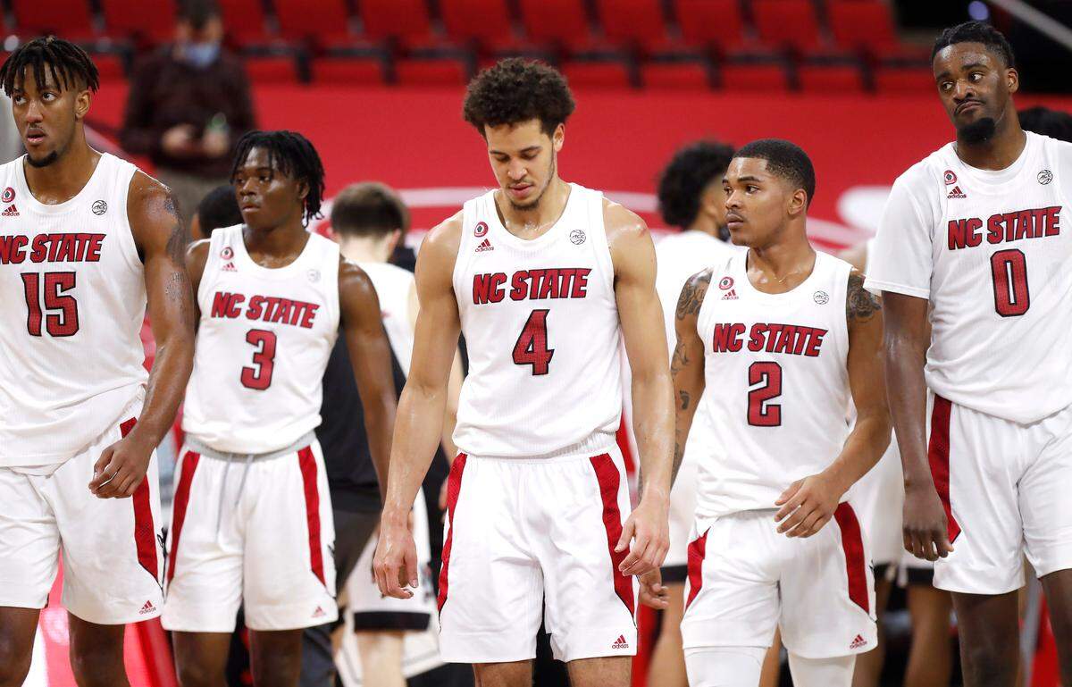 From left, N.C. State’s Manny Bates (15), Cam Hayes (3), Jericole Hellems (4), Shakeel Moore (2), and D.J. Funderburk (0) walk back towards the basket after a timeout during the second half of Duke’s 69-53 victory over N.C. State at PNC Arena in Raleigh, N.C., Saturday, February 13, 2021.