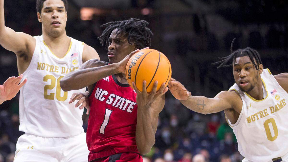 North Carolina State’s Dereon Seabron (1) gets pressure from Notre Dame’s Paul Atkinson Jr. (20) and Blake Wesley (0) during the first half of an NCAA college basketball game Wednesday, Jan. 26, 2022, in South Bend, Ind.