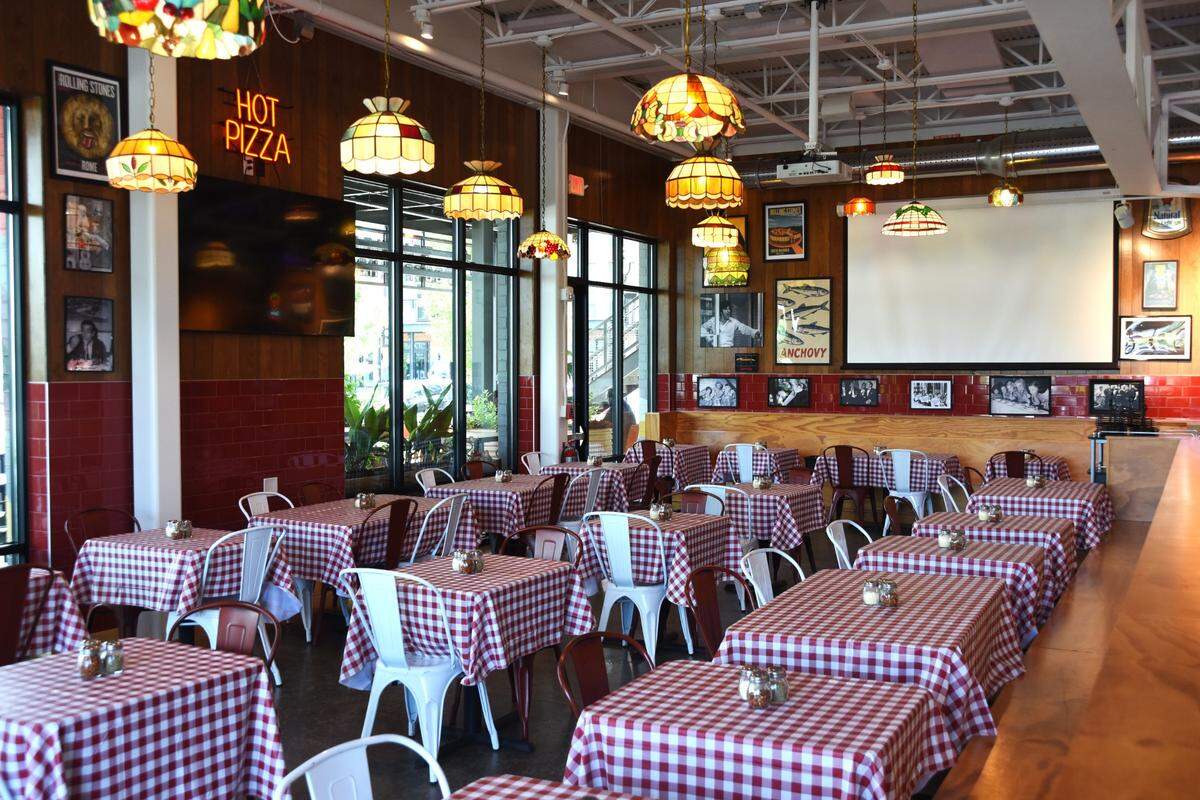 Dino’s Pizza is built for nostalgia, with red tablecloths and Tiffany lamps.