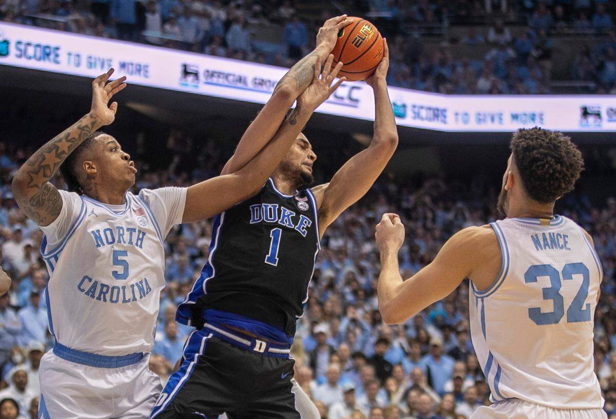 Duke’s Dereck Lively II (1) secures a defensive rebound over North Carolina’s Armando Bacot (5), after a miss by North Carolina’s Caleb Love (2) with :05 seconds to play, securing the Blue Devils’ 67-52 victory on Saturday, March 4, 2023 at the Smith Center in Chapel Hill, N.C.