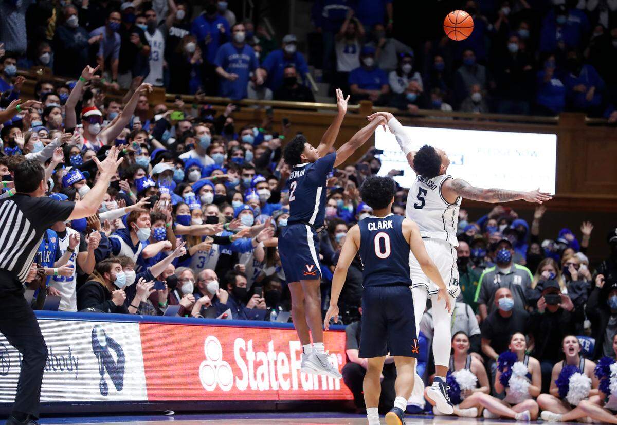 Virginia’s Reece Beekman (2) hits what will be the game winning three-pointer with one second left in the game during Virginia’s 69-68 victory over Duke at Cameron Indoor Stadium in Durham, N.C., Monday, Feb. 7, 2022.