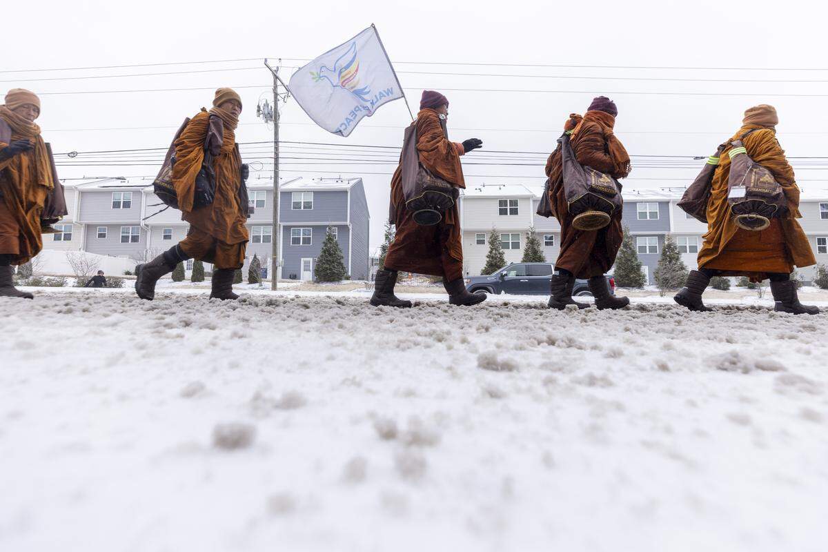 Despite winter weather conditions, a procession of Buddhist monks walks along Buffaloe Road on Sunday, Jan. 25, 2026, in Raleigh. The monks are making a 2,300-mile pilgrimage from Texas to Washington, D.C., as part of the Walk for Peace, an effort to promote peace, compassion and national unity.