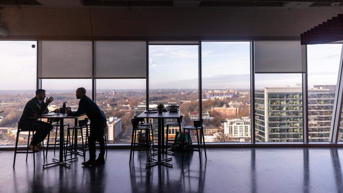 Pendo employees talk in a break area inside the Pendo building in downtown Raleigh.