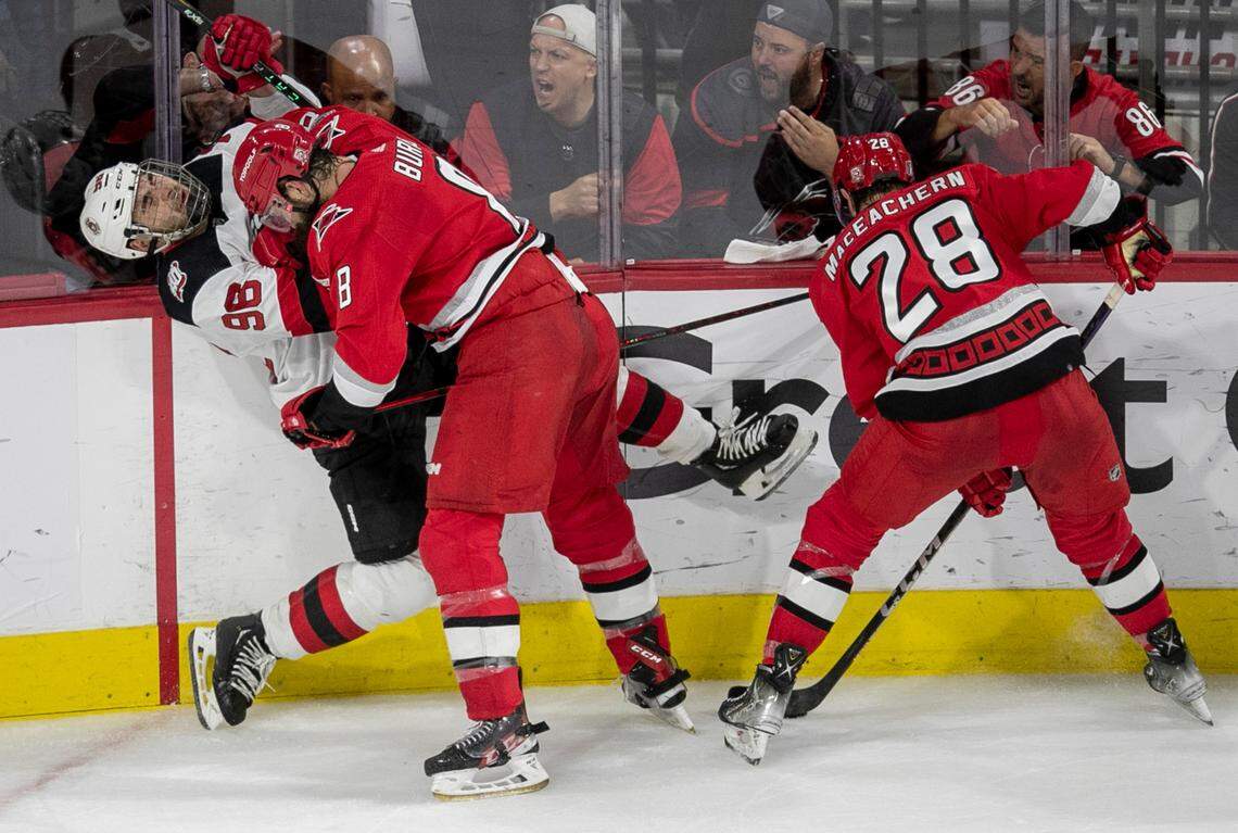 The Carolina Hurricanes Brent Burns (8) checks the New Jersey Devils Timo Meier (96) into the boards in the second period during Game 5 of their second round Stanley Cup playoff series on Thursday, May 11, 2023 at PNC Arena in Raleigh, N.C.