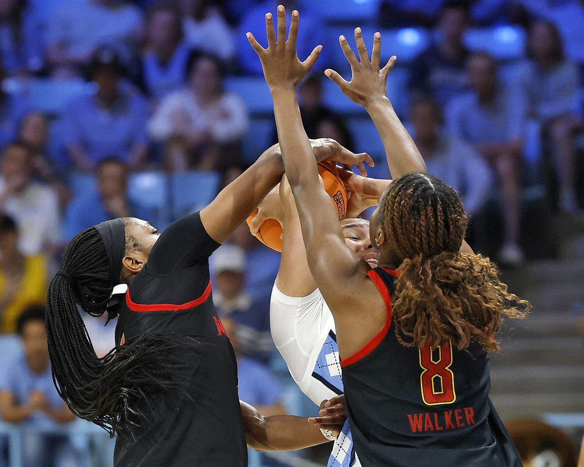 Maryland’s Oluchi Okananwa and Kyndal Walker pressure North Carolina’s Taissa Queiroz during the second half of the Tar Heels’ 74-66 second-round NCAA Tournament win over Maryland on Sunday, March 22, 2026, at Carmichael Arena in Chapel Hill, N.C.