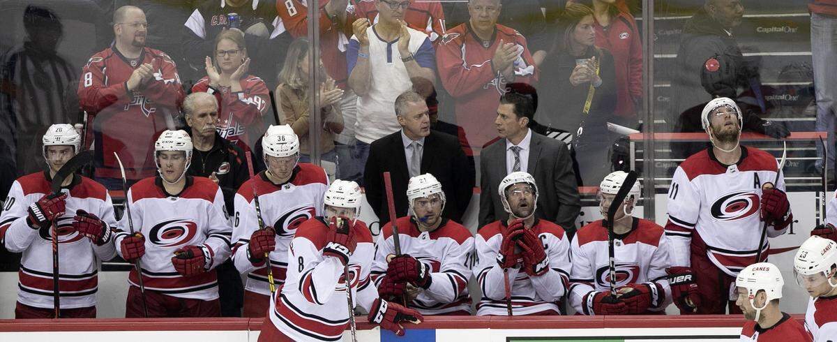 Carolina Hurricanes coach Rod Brind’Amour talks with coach Jeff Daniels as his team watches a replay of a goal by Washington Capital’s Nicklas Backstrom (19) in the second period during game five of their first round Stanley Cup series against the Washington Capitals on Saturday, April 20, 2018 at Capital One Arena in Washington, D.C.