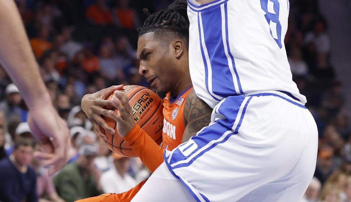Clemson's Jestin Porter (1) drives by Duke’s Darren Harris (8) during the first half of Duke’s game against Clemson in the semifinals of the 2026 ACC Men’s Basketball Tournament at the Spectrum Center in Charlotte, N.C., Friday, March 13, 2026.