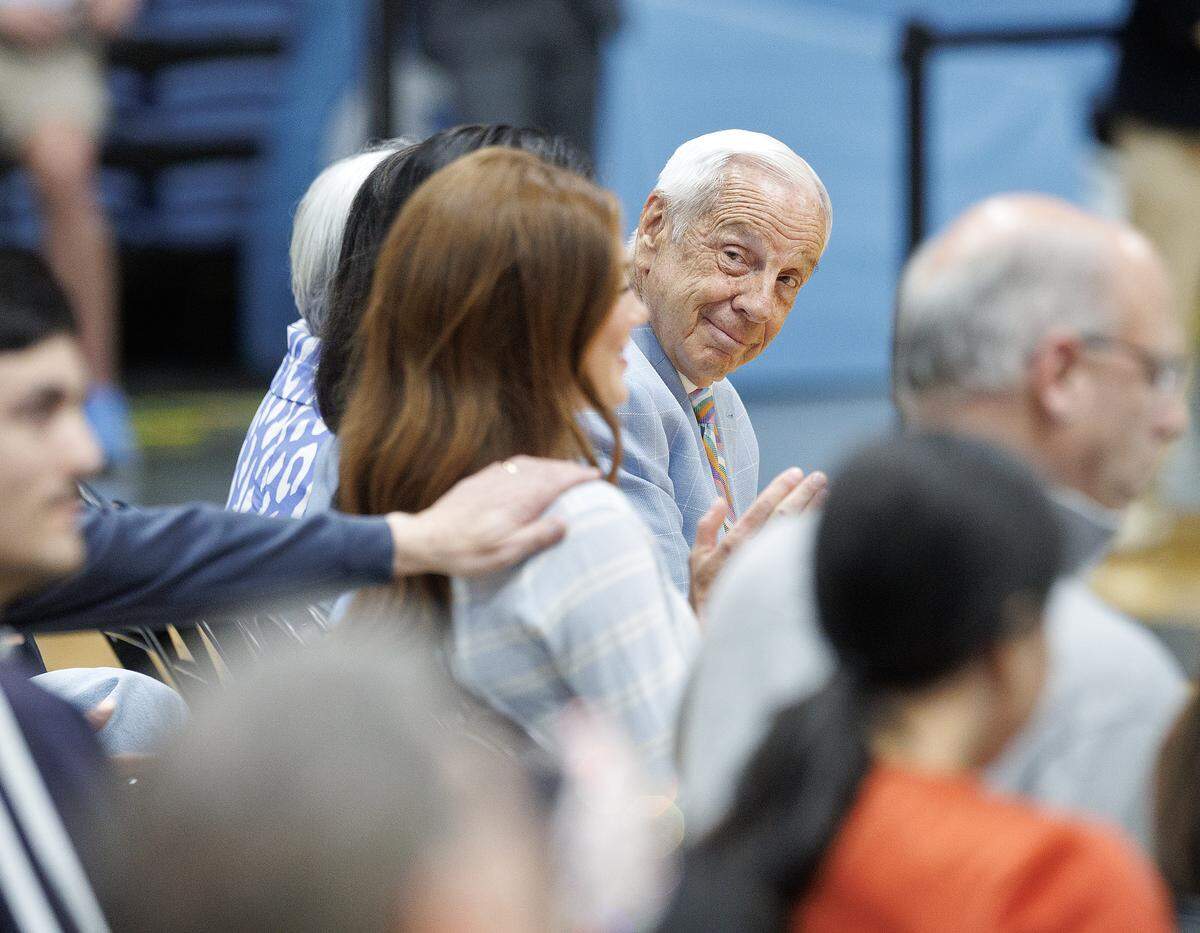 Roy Williams smiles as new North Carolina men’s basketball head coach Michael Malone talks about his daughter, Bridget, a freshman volleyball player, during Malone’s introductory press conference at the Smith Center on Tuesday, April 7, 2026, in Chapel Hill, N.C.