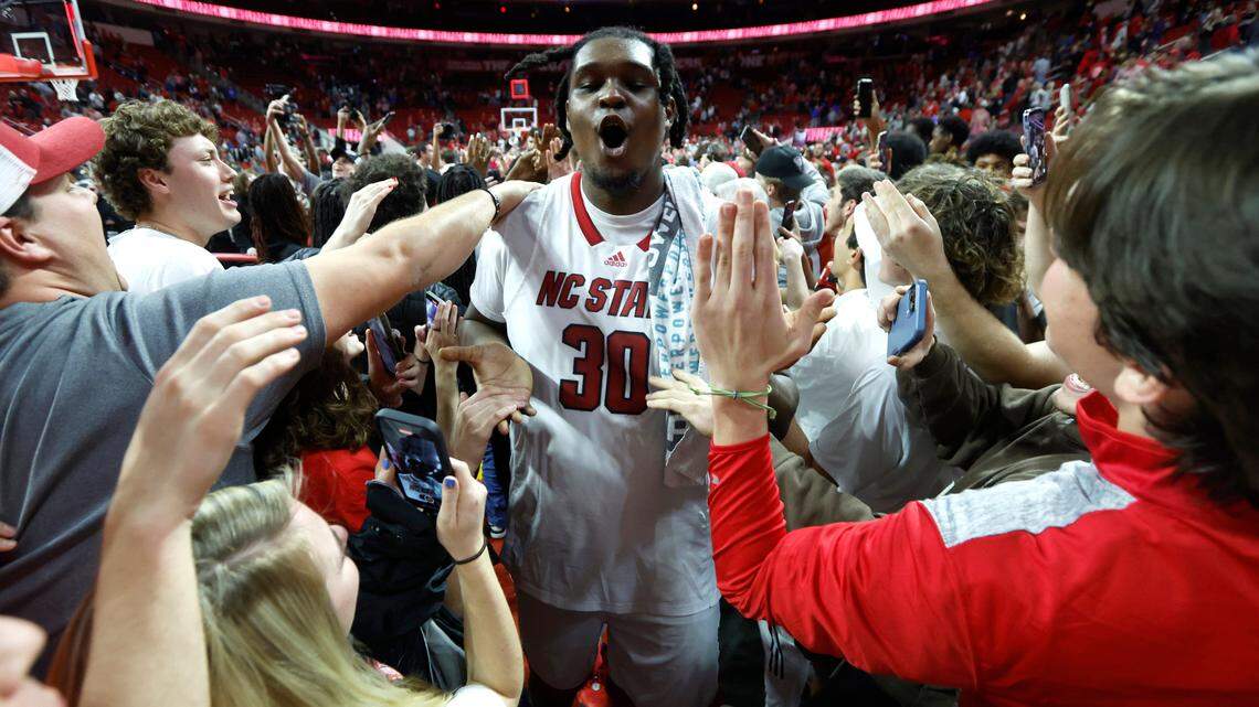 N.C. State’s D.J. Burns Jr. (30) is surrounded by fans as he exits the court after N.C. State’s 84-60 victory over Duke at PNC Arena in Raleigh, N.C., Wednesday, Jan. 4, 2023.