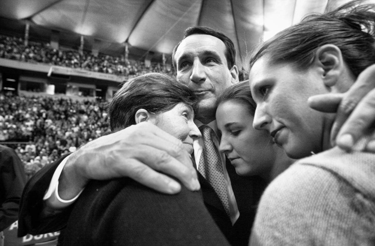 Mike Krzyzewski gets a family hug from wife Mickie (left) and daughters Jamie (middle) and Lindy (right) after the Blue Devils’ NCAA championship win, April 2, 2001 in the Metrodome.