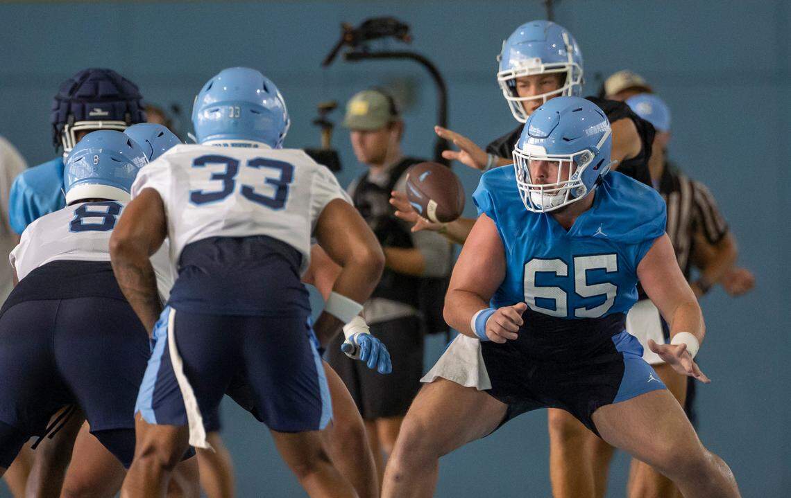 North Carolina offensive lineman Corey Gaynor (65) protects quarterback Drake aye (10) during the Tar Heels’ first practice of the season on Wednesday, August 2, 2023 in Chapel Hill, N.C.