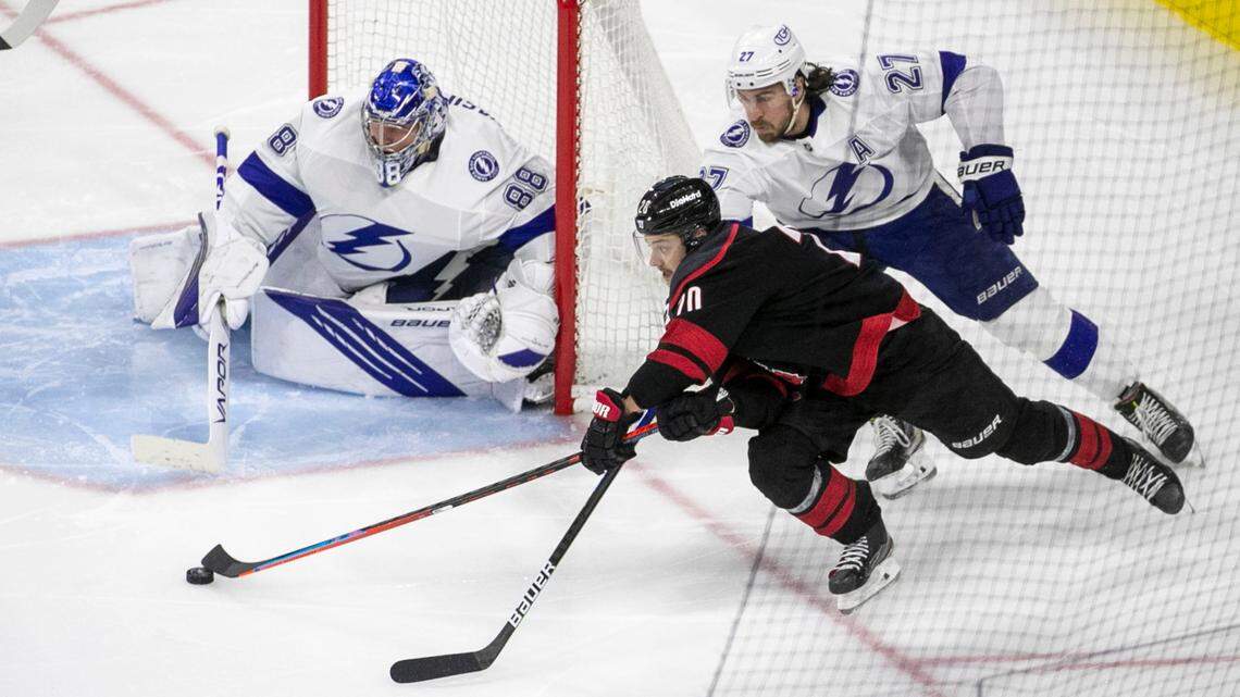 Carolina Hurricanes Sebastian Aho (20) works the puck against Tampa Bay’s Ryan McDonagh (27) in the third period of game five of their Stanley Cup series against Tampa Bay on Tuesday, June 8, 2021 at PNC Arena in Raleigh, N.C.