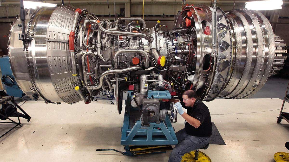 At GE Aviation’s facility in Durham assembly test technician Chris Patterson works on a new engine for a jumbojet. Plant workers are starting to do repair work on engines for various airlines. The shift in work, while small for now, is the latest effort by manufacturers to ride out the recession by tackling new tasks.