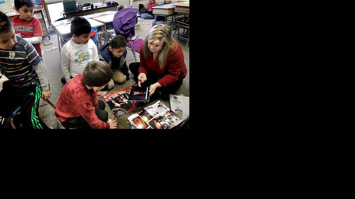 Second grade Teacher Kathy Etheridge, far right, works with some of her 23 students, like like Kyle Burgess, front-center, Daniel Gomez-Cervantes, white shirt and Caleb Leach, second from right, during a small-group reading time at Vance Elementary School in Raleigh, N.C. on Thursday, February 5, 2015.
