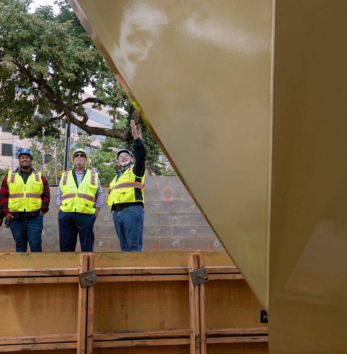 Jordan Milhouse, Reginald Hodges and Larry Longworthy inspect the newly installed Beacon of Freedom in Freedom Park on Thursday, September 29, 2022 in Raleigh, N.C.